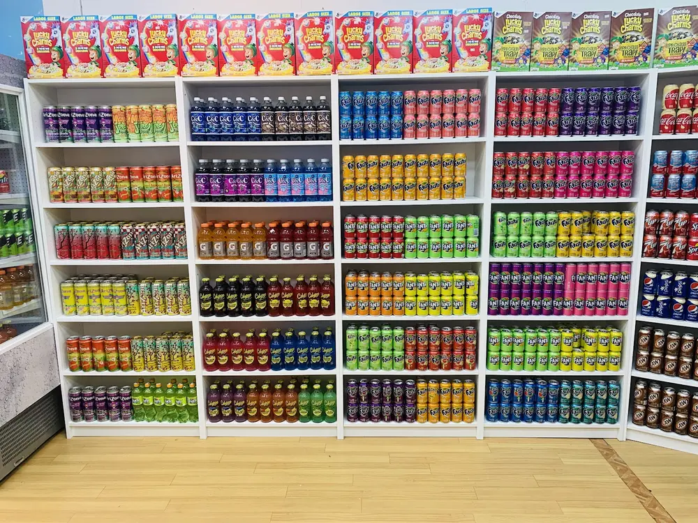 Shelves stacked with Fanta, Arizona, Calypso, C&C and boxes of Lucky Charms